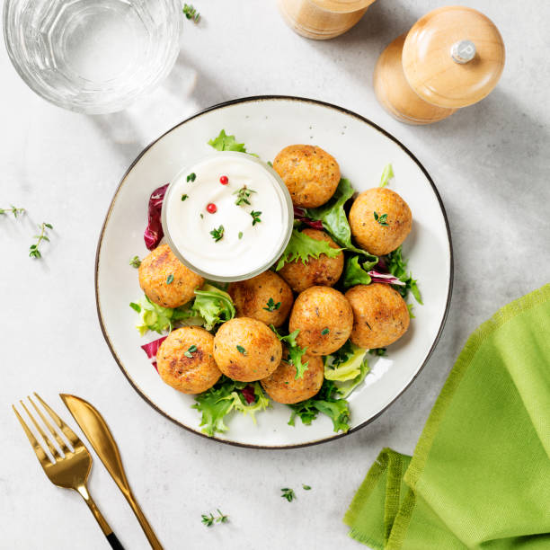 Vegetarian chickpeas falafel balls Vegetarian chickpeas falafel balls with fresh green salad. Traditional Middle Eastern and arabian food. top view kosher starter recipes stock pictures, royalty-free photos & images