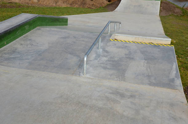 istock Skateboard park with concrete cement surface with concrete skateboard obstacles is designed for roller sports. Cycling is not allowed except for freestyle bikes. Protective clothing, head, elbow knee 1368889671