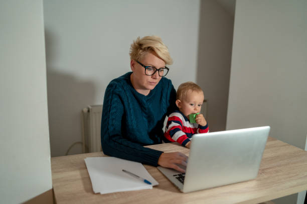 istock Mother and son at home, having fun together, using laptop. 1368890496