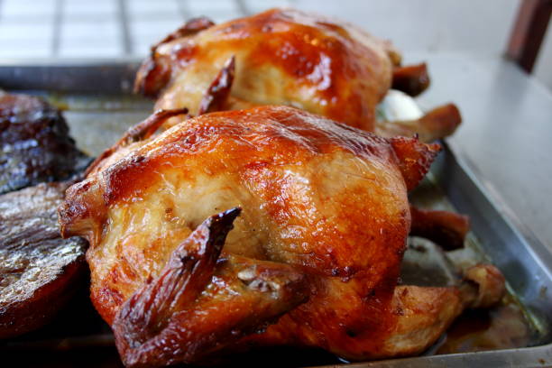 istock Whole chicken roasted on tray. 1368890699