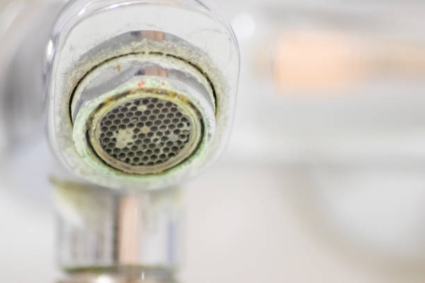 istock Old scaled faucet as calcified chrome handle in the bathroom needs maintenance and decalcification with cleaning agents to stop leakage and improve hygiene bacteria of old handle with droplet poverty 1368890832