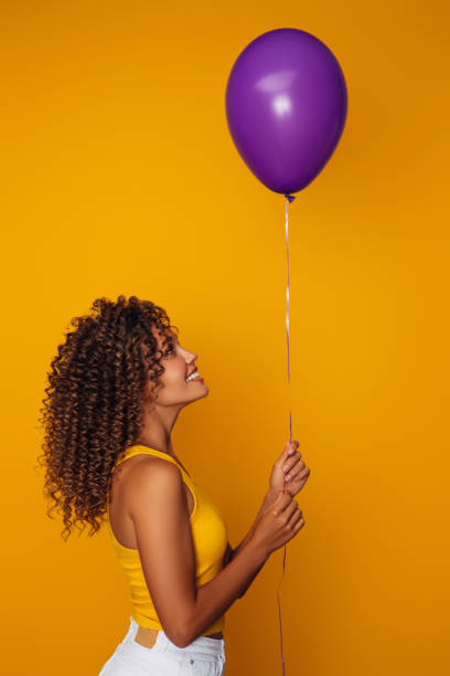 istock Beautiful woman holding a balloon 1368892521