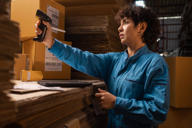 istock People working in storage, taking parcel and scanning barcode, putting box on shelf. Female business person at workplace in warehouse, concept of delivering and logistics. Businesswoman owner. 1368893601