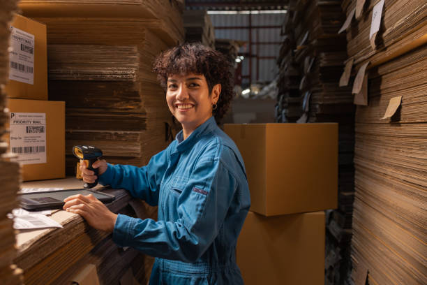 istock People working in storage, taking parcel and scanning barcode, putting box on shelf. Female business person at workplace in warehouse, concept of delivering and logistics. Businesswoman owner. 1368893602