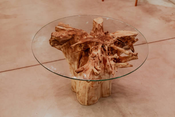 istock Wood table made of the dry tree root and round glass table top 1368893704