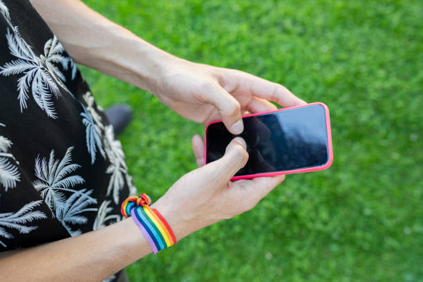 istock hands using a mobile wears an lgbt bracelet 1368894608