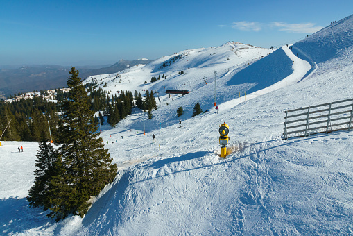 Skiers at Jahorina ski resort, Bosnia and Herzegovina on sunny day.