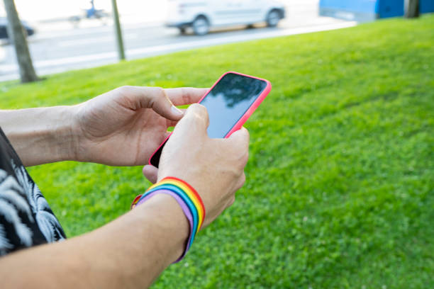 istock hand with smartphone rainbow bracelet lgbt 1368894815
