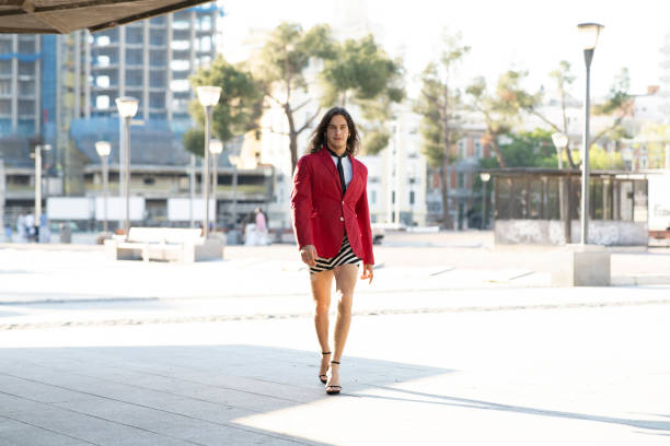 istock man dressed in women's clothes on the street 1368897114