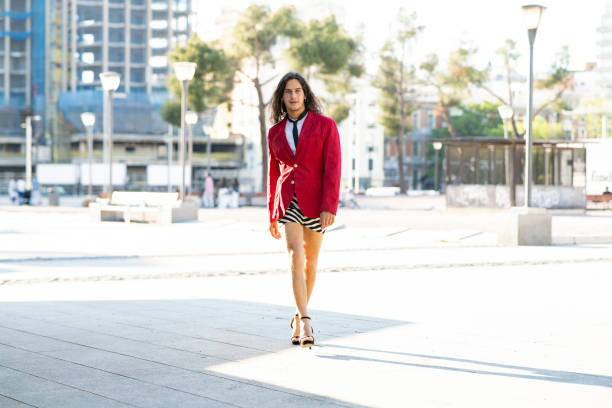 istock man dressed in women's clothes on the street 1368897883