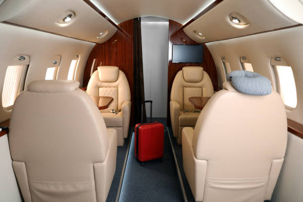 istock Airplane cabin with red suitcase. Air travel 1368900599