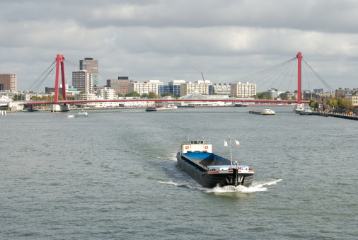Barge heading down the Nieuwe Maas in Rotterdam, photographed from the Erasmusbrug.