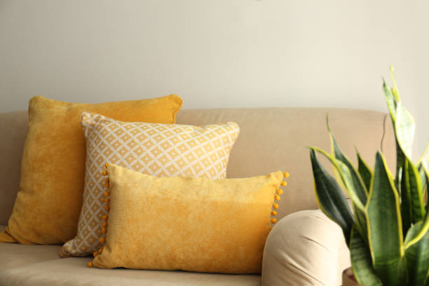istock Three pillows on sofa near wall in room. Interior design 1368903214