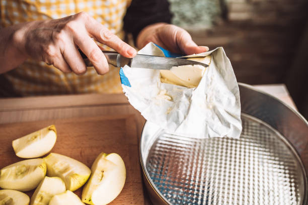 Making apple charlotte - buttering with a metal detachable baking dish