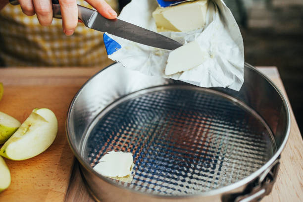 istock Woman puts butter in a detachable baking dish 1368904615