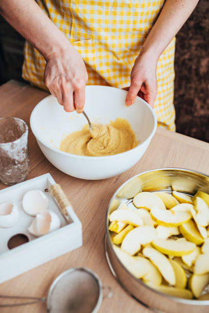 istock Woman kneads dough in a white bowl 1368904660
