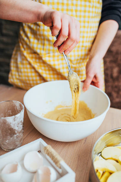 Thick homogeneous flowing dough in a white bowl ready for baking