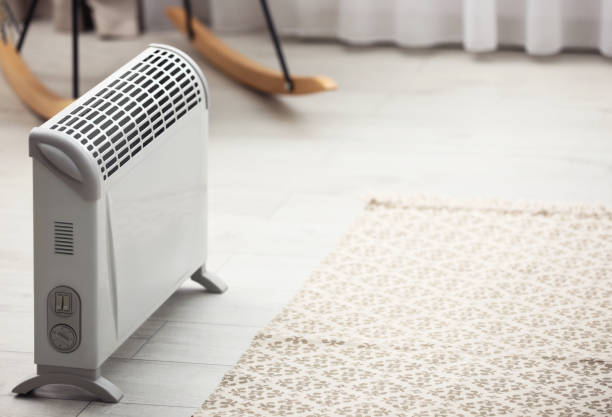 istock Modern electric heater in stylish room interior. Space for text 1368904826
