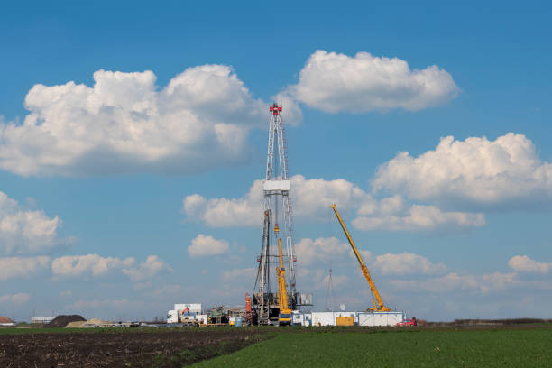 oil drilling rig and cranes on field