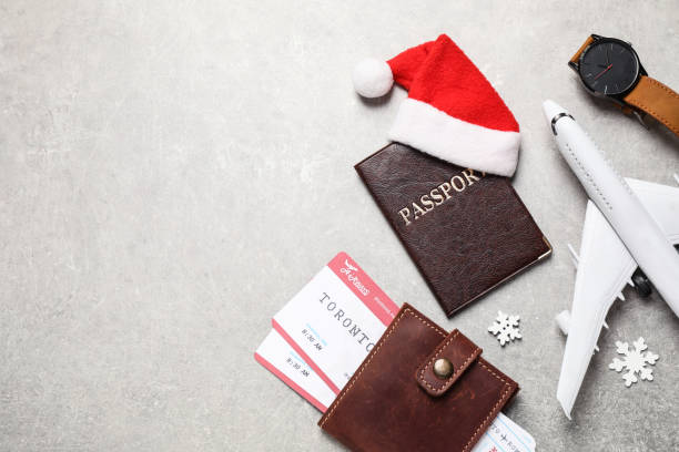 istock Flat lay composition with Santa hat and passport on light table, space for text. Christmas vacation 1368905261