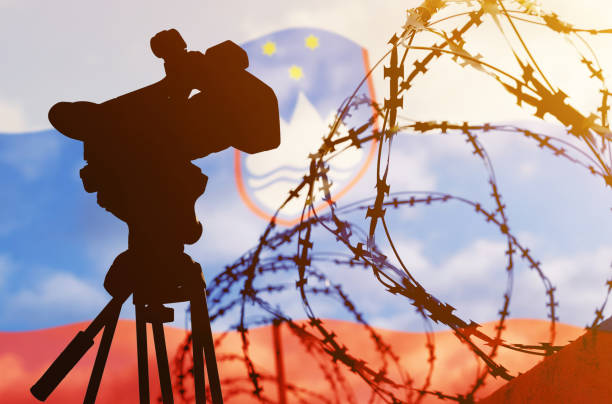 istock Double exposure - camera, barbed wire and flag Slovenia 1368907092