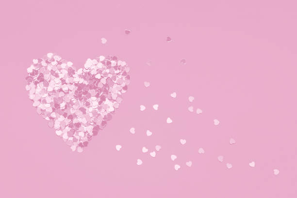 istock Monochromatic pink heart shape made of confetti 1368907149