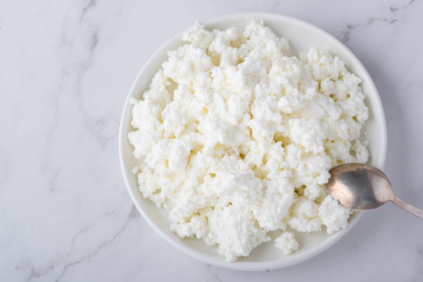 istock Bowl with fresh cottage cheese on table. Space for text 1368909648