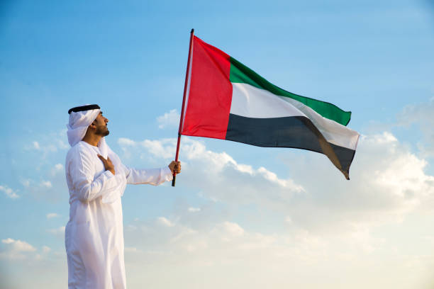 istock Arabic man with emirates flag in the desert 1368911788