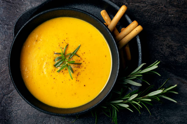 istock Pumpkin soup with linen napkin on dark background. 1368911997