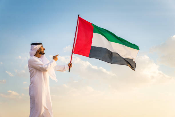 istock Arabic man with emirates flag in the desert 1368912315