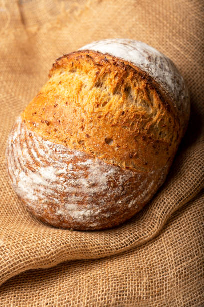 istock Wholemeal sourdough bread isolated on burlap cloth. 1368912859