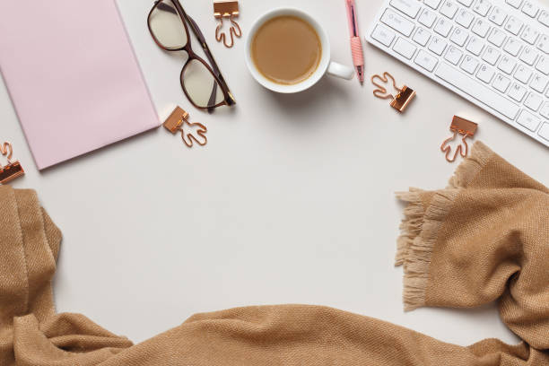 istock Desktop. Notepad keyboard cup coffee glasses cashmere scarf on the table. Frame flat lay copy space top view 1368913109
