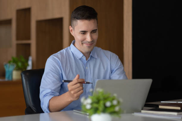 istock smiling businessman having virtual team meeting call, talking, remotely working at home watching online learning training webinar in remote office 1368913367