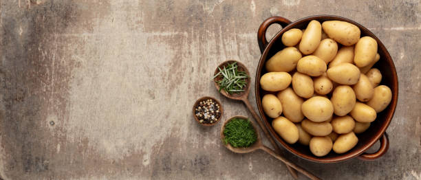 istock Raw small potatoes in a cast iron skillet on a beton background. 1368913530