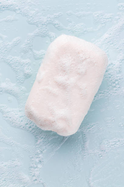 istock Soap bar and foam on white background, top view. Mockup for design 1368913532