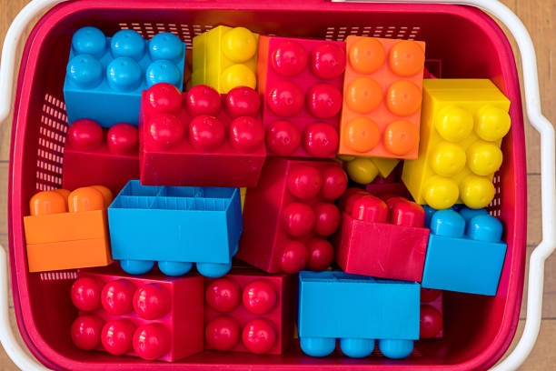 istock Plastic basket with toy blocks for children game top close view 1368913647