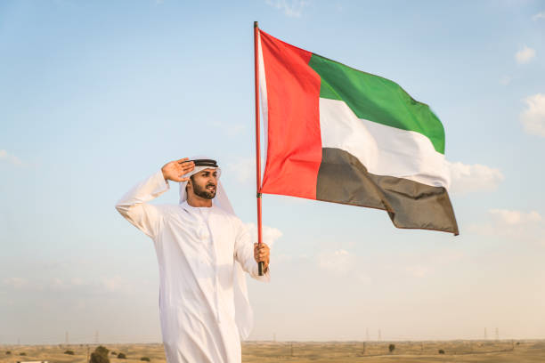 istock Arabic man with emirates flag in the desert 1368914348