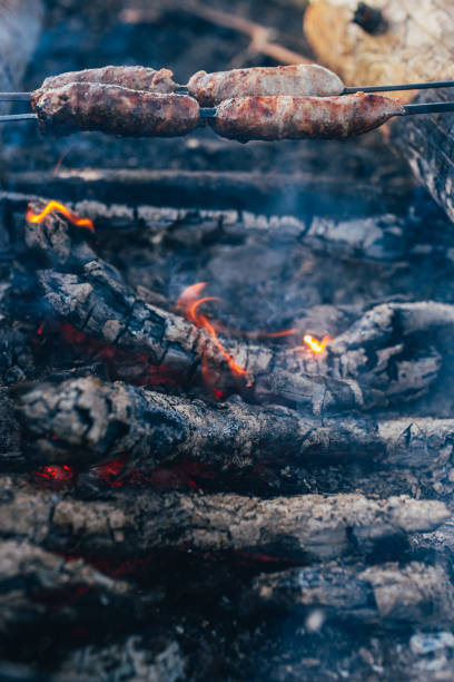 istock Rustic sausage on a skewer at the stake - sausages are fried over an open fire 1368914372