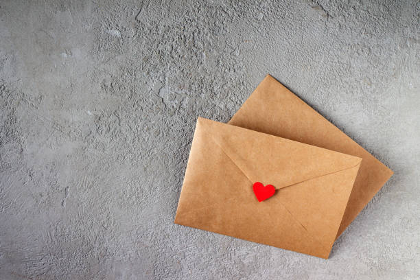 istock craft envelopes with red paper hearts on gray plaster 1368914377