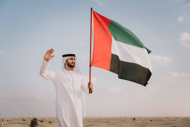 istock Arabic man with emirates flag in the desert 1368914414