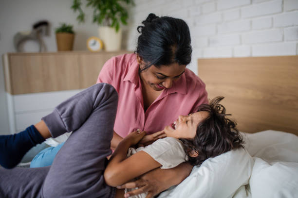 istock Indian mother hugging her little son and having fun at home. 1368914554