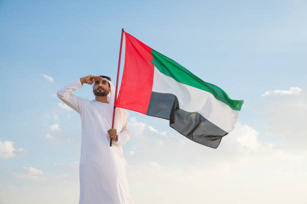 istock Arabic man with emirates flag in the desert 1368914641
