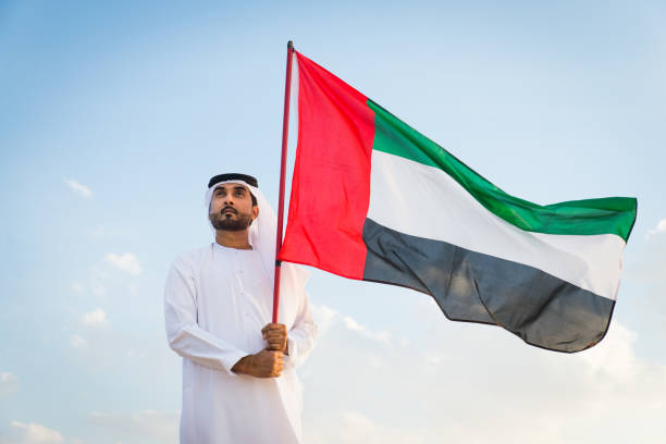 istock Arabic man with emirates flag in the desert 1368916208