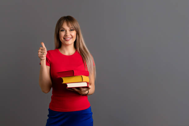 istock Young Woman with Three Books 1368916265