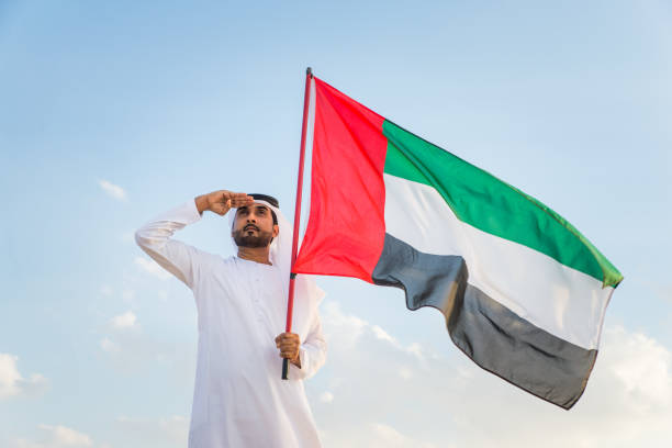 istock Arabic man with emirates flag in the desert 1368916994