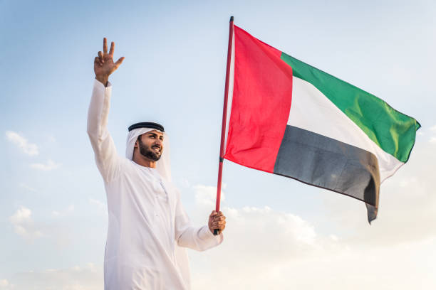 istock Arabic man with emirates flag in the desert 1368917013