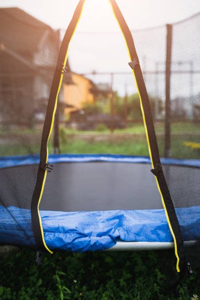 istock Trampoline in the backyard - entrance through an open net 1368917196