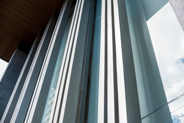 istock Vertical Extruded aluminum window frames and glass curtain wall - architectural element for the exterior design of a house. 1368918519