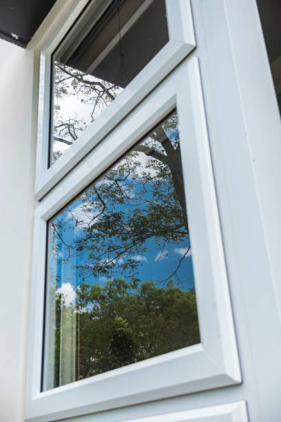 istock A single glazed window as seen from the outside, reflecting an Acacia tree and the blue sky. Slight reflection blur. 1368918775