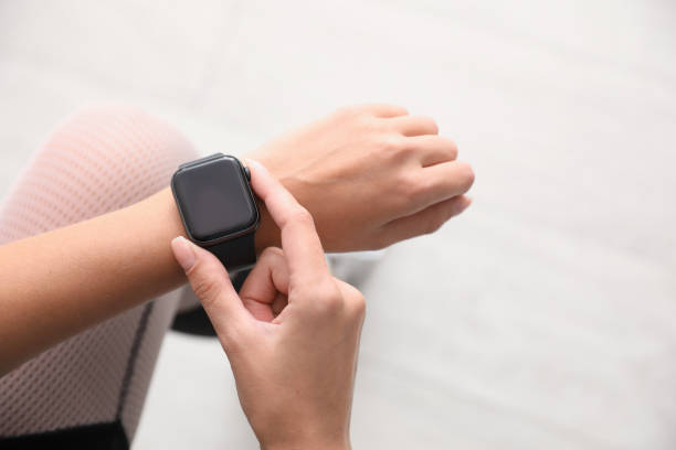 istock Woman using stylish smart watch indoors, top view 1368920145